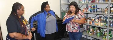 Three Women inside a Food Pantry