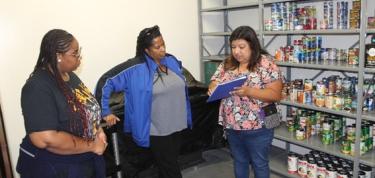 Three Women inside a Food Pantry